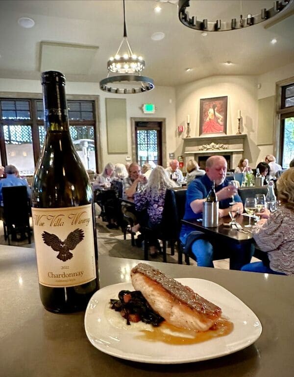 plate of food on counter next to wine bottle